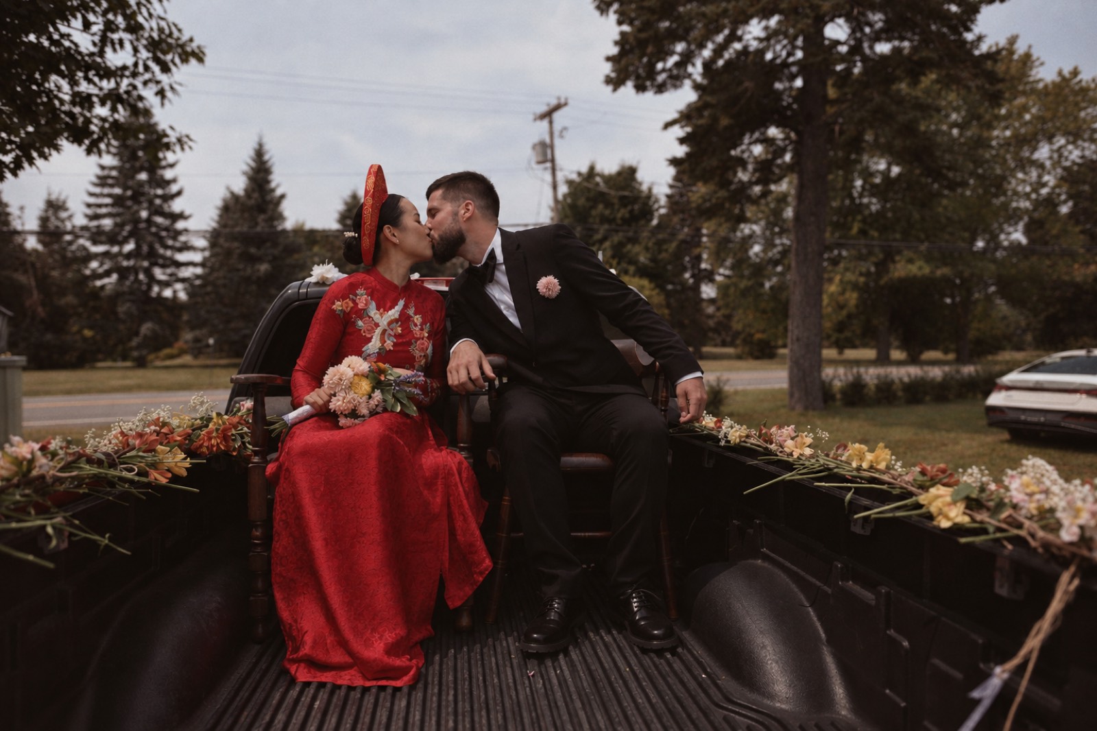 Thu and Simon kiss in the bed of a truck in Rougemont, Quebec