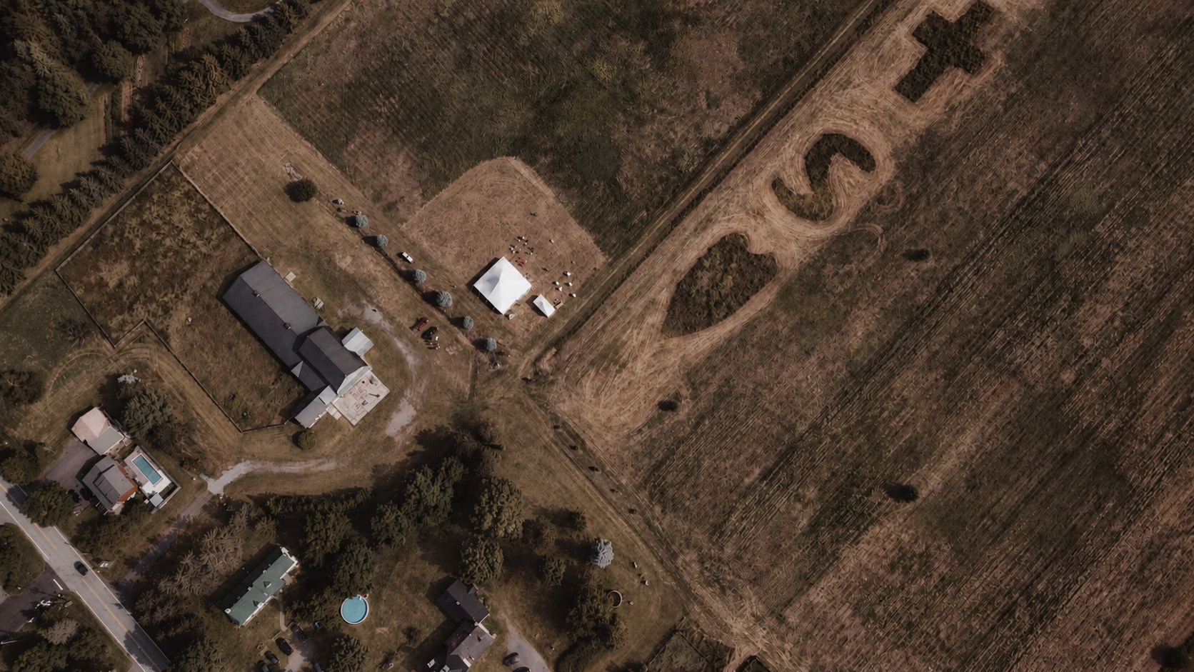 Aerial view of the countryside homestead at Thu and Simon's wedding in Rougemont, Quebec