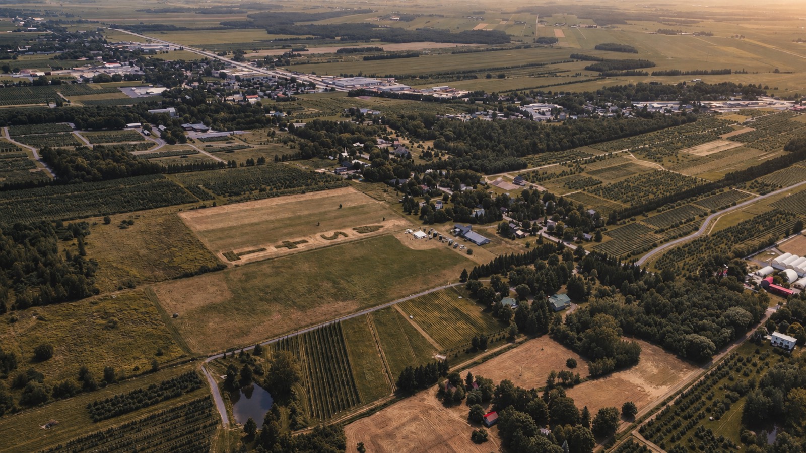 Golden-hour aerial of the countryside at Thu and Simon's wedding in Rougemont, Quebec