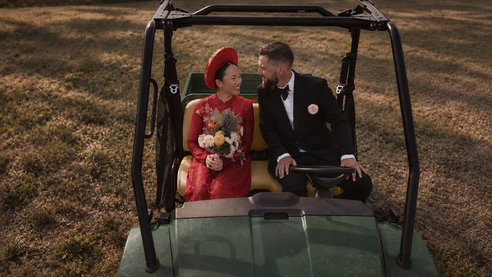 Thu and Simon as newlyweds in a green cart in Rougemont, Quebec