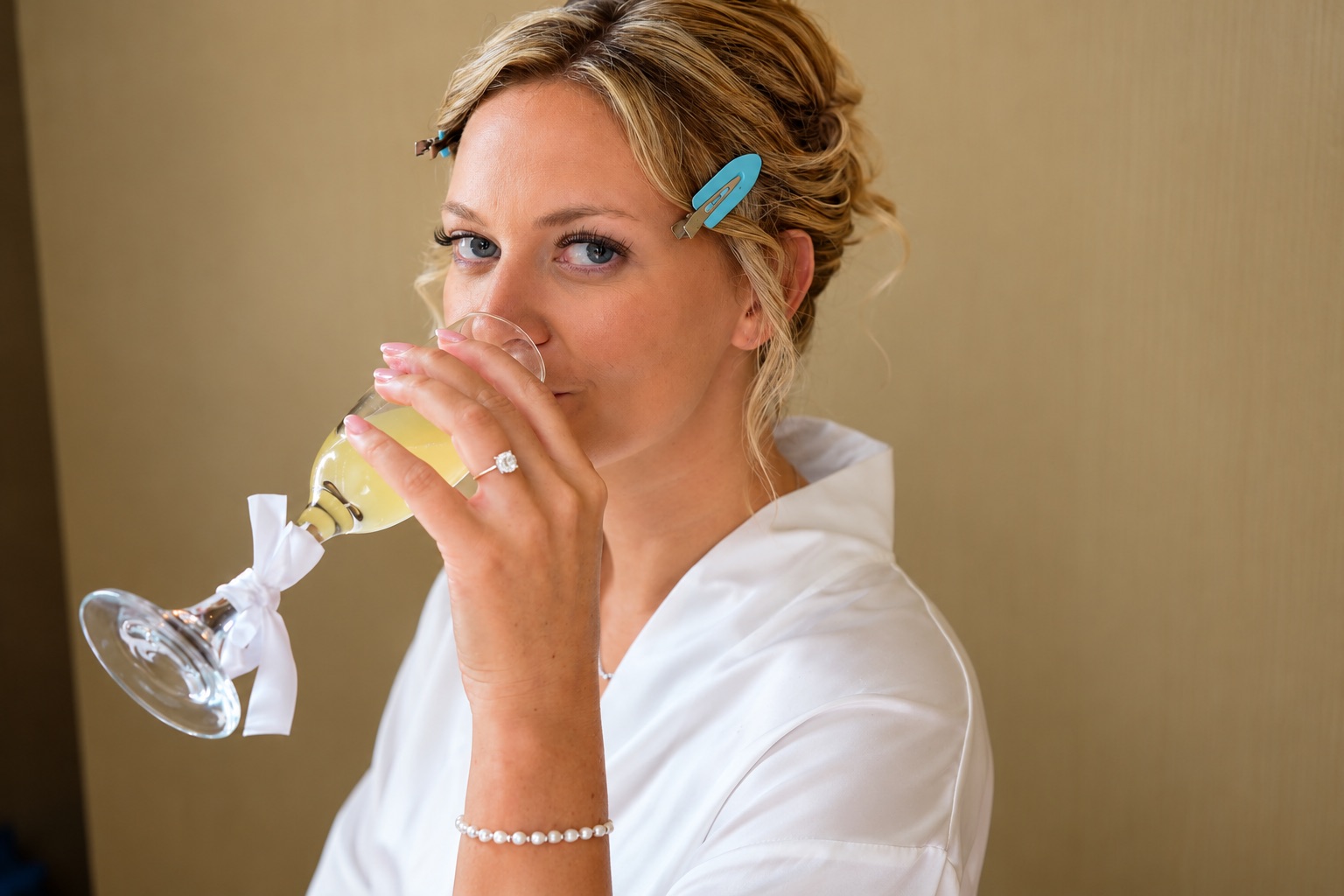 Jaci sips a mimosa while getting ready in Watertown, Upstate New York