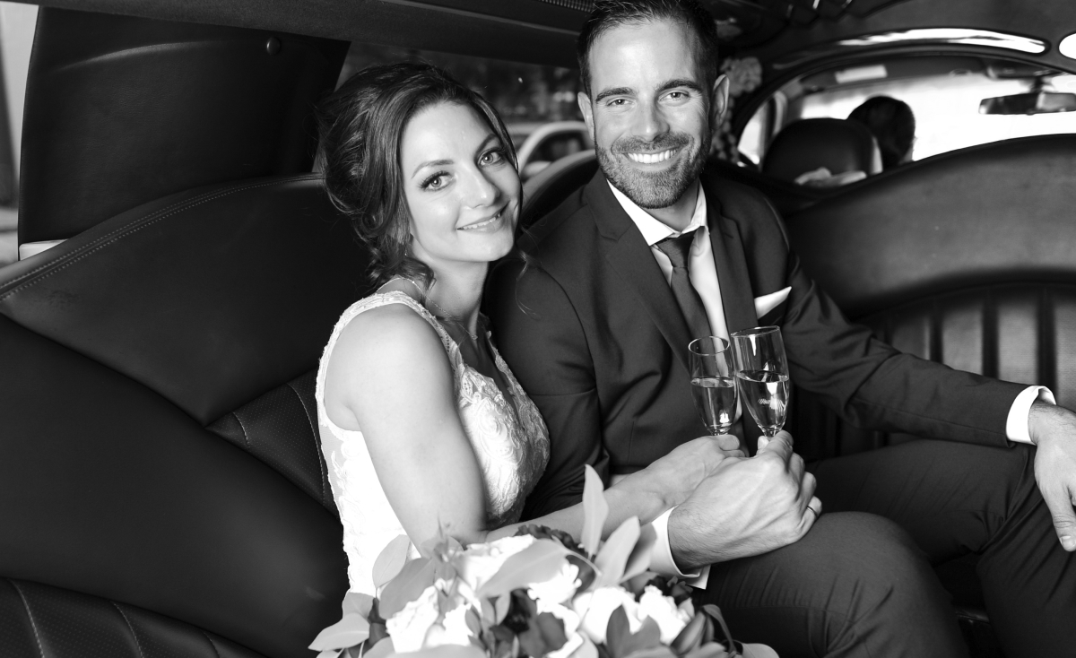 Kristine and Kenneth with champagne in the car