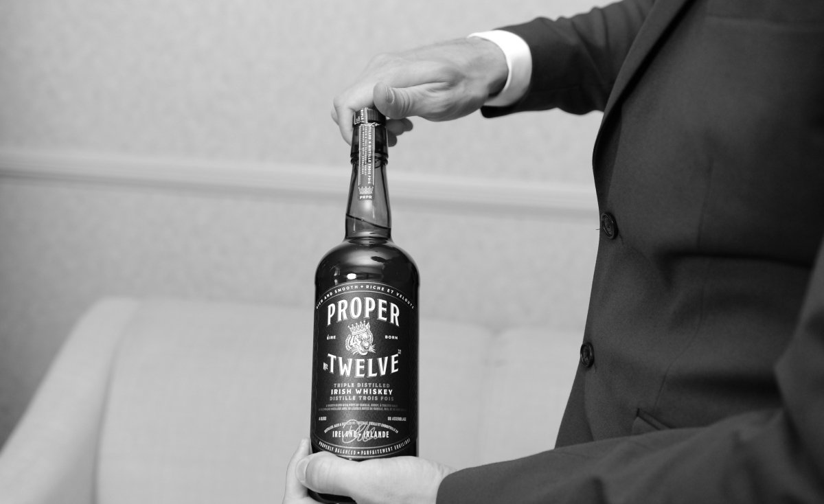 Kenneth opening a bottle of Irish whiskey