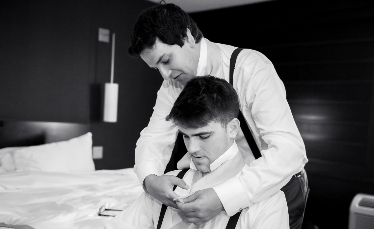 Groomsmen helping each other get ready