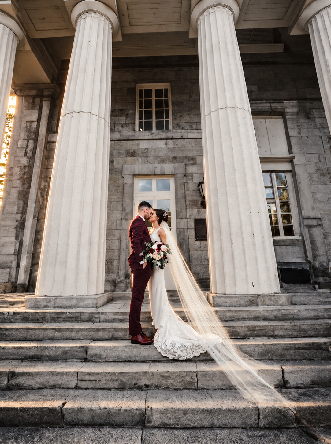 Kristine and Kenneth kissing on the steps of Marché Bonsecours