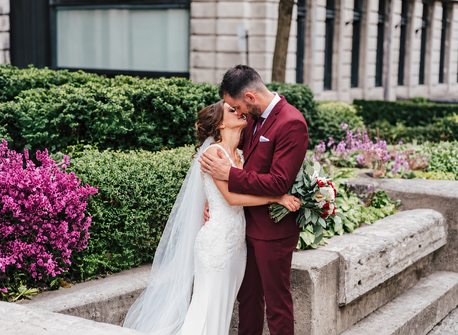 Kristine and Kenneth kissing in a garden