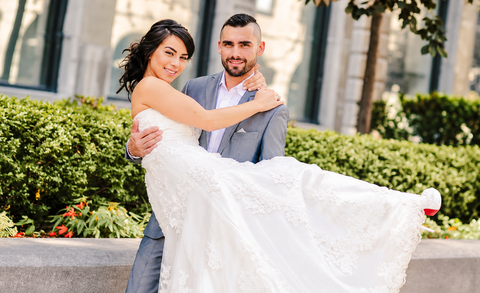 Kevin lifting Sara in her wedding dress